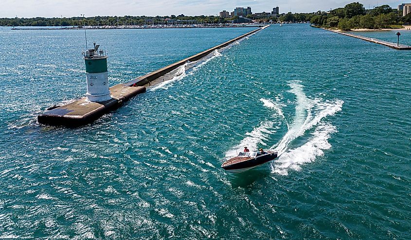 Classic boat on the water by Waukegan Lighthouse