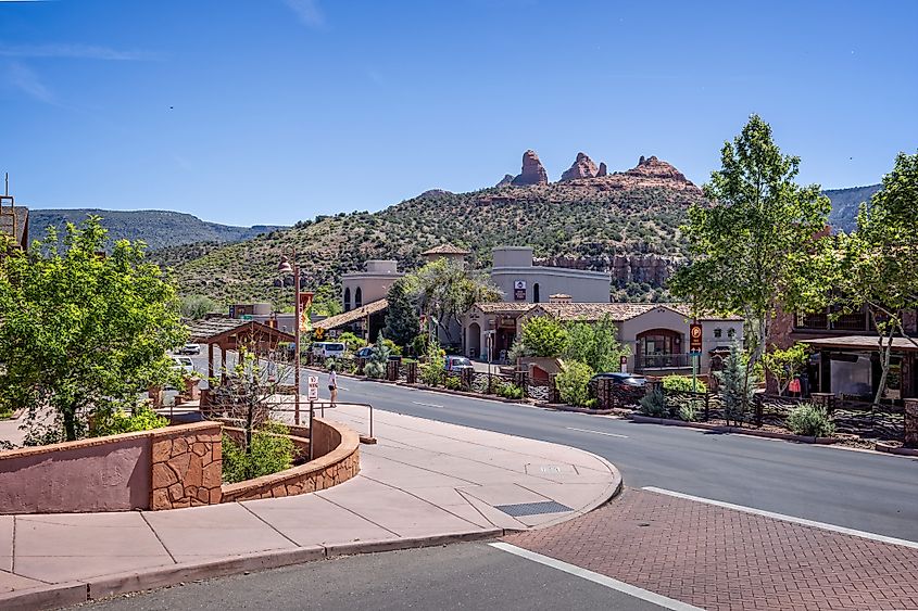 Uptown Sedona shops with red rock buttes in the background in Sedona, Arizona.