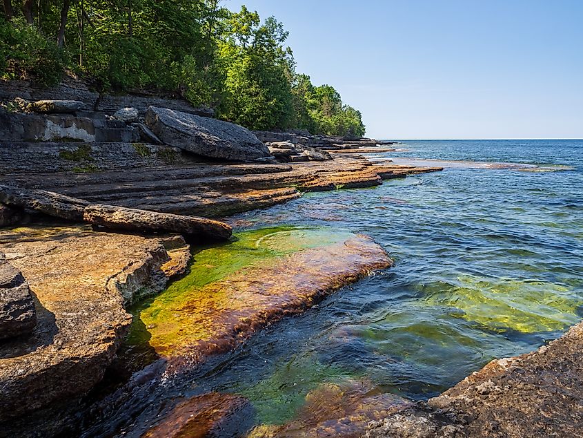 water cascading over moss-covered cliffs by Lake Ontario at Robert G. Wehle State Park in upstate New York