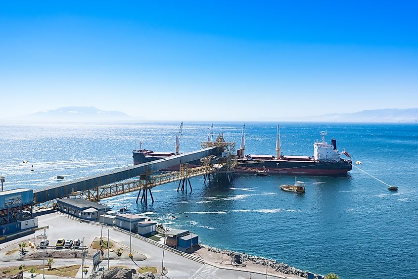 Cargo ship docked at Puerto Coloso, serving mining shipments from Escondida Mine. Editorial credit: Jose Luis Stephens / Shutterstock.com