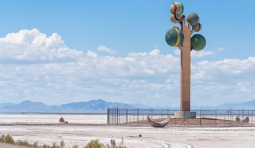 The Tree of Utah famous colorful sculpture on interstate 80 at desert landscape with salt flats and mountains in background