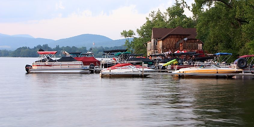 Boats docked next to a wooden boathouse on Pontoosuc Lake in Pittsfield, Massachusetts.