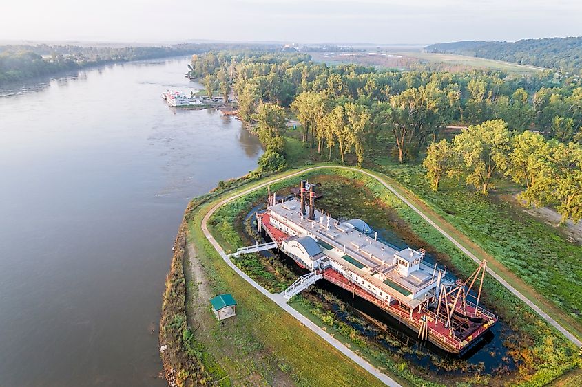 Aerial view of a hazy sunrise over the Missouri River with the historic dredge Captain Meriwether Lewis in a dry dock on the shore in Brownville, Nebraska