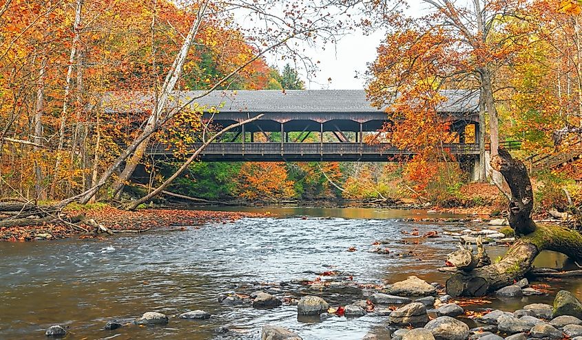 Mohican Covered Bridge spanning over clear fork Mohican river in autumn. Mohican State Park. Perrysville. Ohio