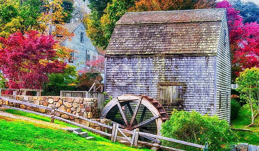 The landmark Dexter Grist Mill and water wheel in Sandwich, Massachusetts in new england during autumn.