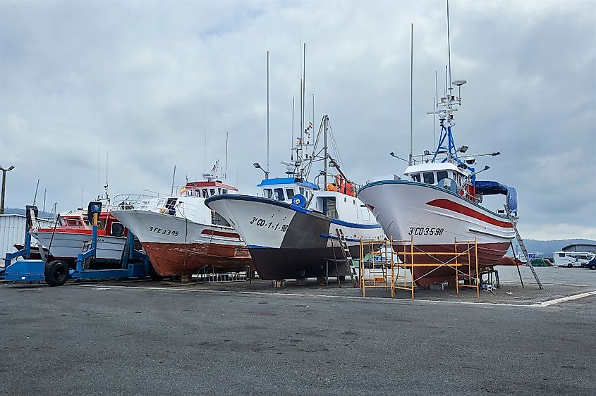 Fishing boats docked in the harbor of Muxía, Spain.