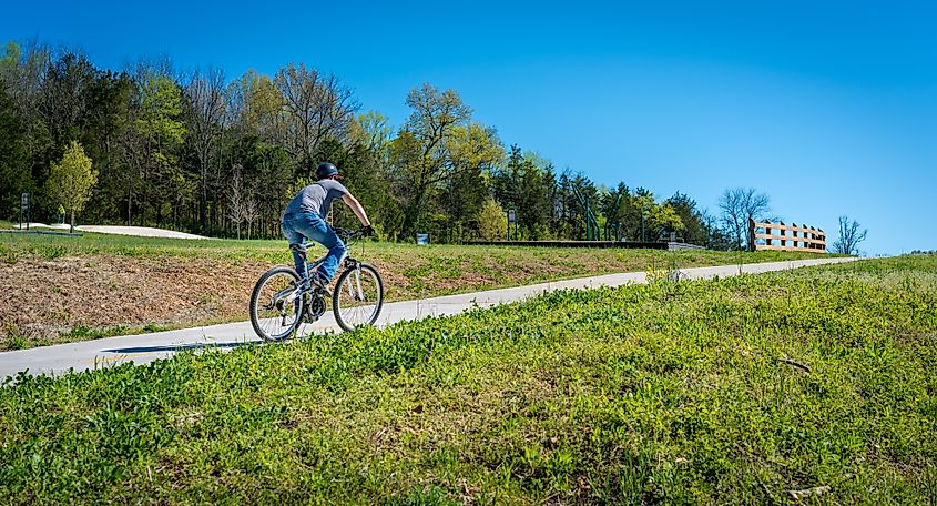 A young man biking on a trail in Bella Vista, Northwest Arkansas.