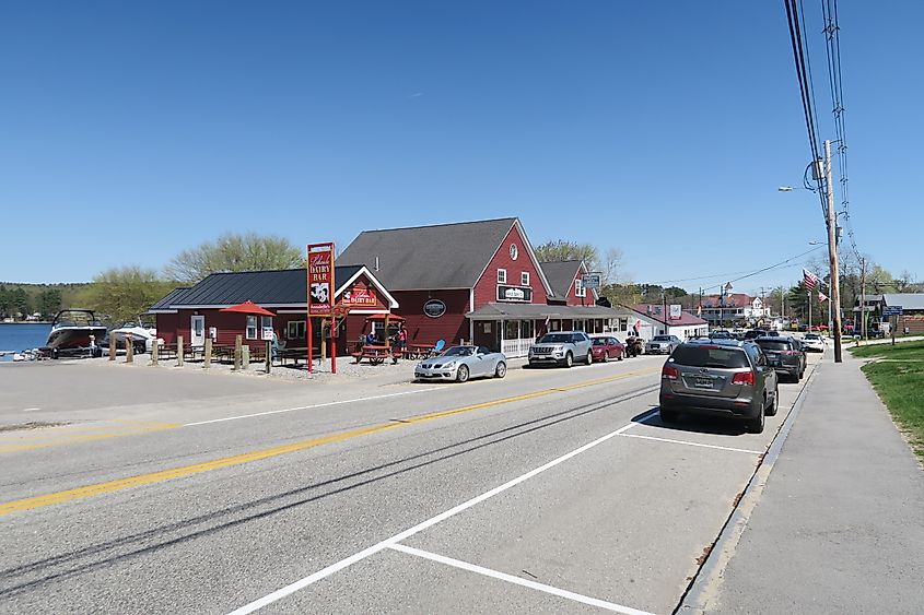 Lakeside Dairy Bar in Naples, Maine, a small, charming roadside spot with a walk-up window, offering views of the lake and outdoor seating for visitors.