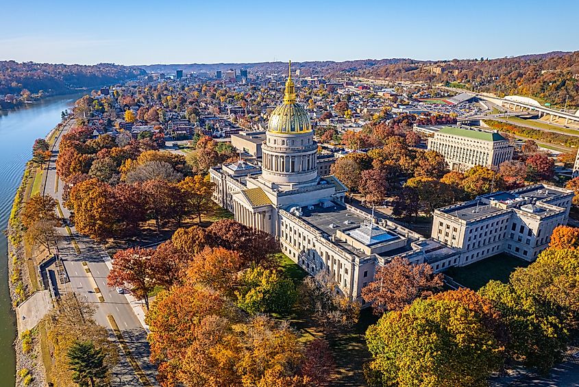 An aerial view of the West Virginia State Capitol Building and downtown Charleston with fall foliage.