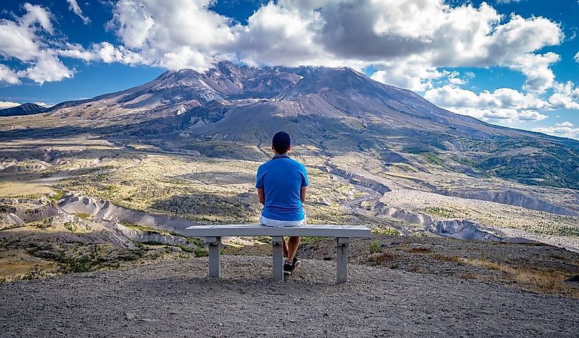 Male sitting on a park bench in Mount St. Helens National Volcanic Monument, Washington.