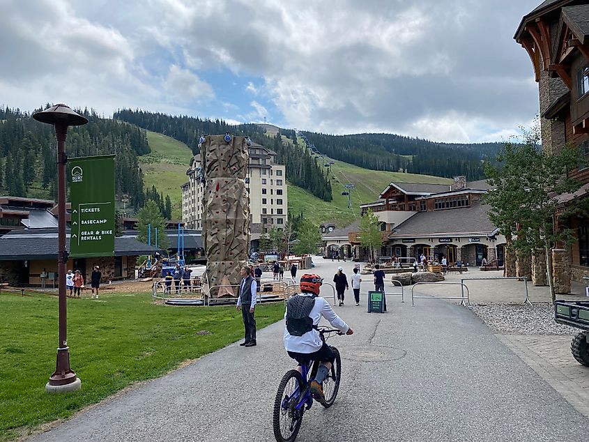 A mountain biker rolls into the village at the base of Big Sky Resort during its summer season. 