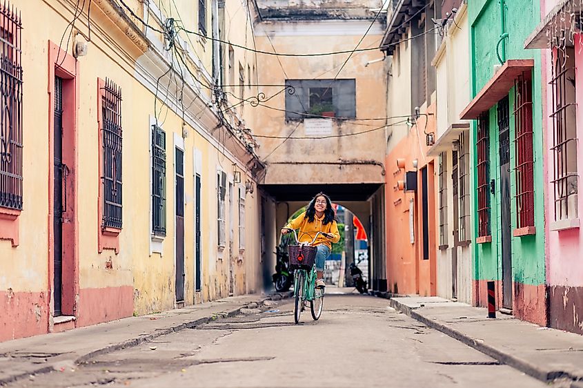 Teen riding a bike in Guatemalan neighborhood. Source: Shutterstock