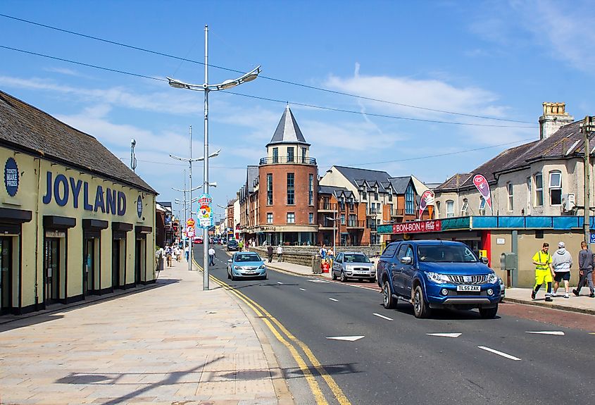 Pedestrians on Central Promenade near the Joylands Amusement Arcade in Newcastle County Down Northern Ireland. Editorial credit: Mick Harper / Shutterstock.com