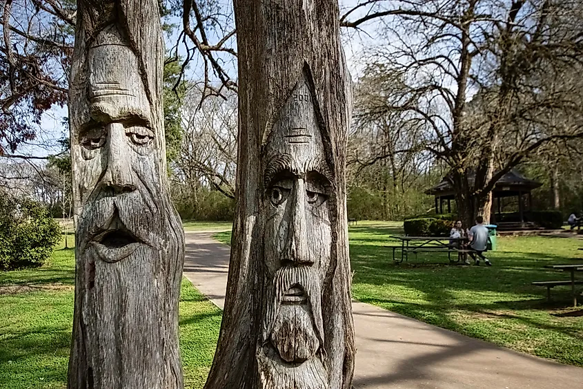 Two of the famous woodcarved faces in Orr Park in Montevallo, Alabama.