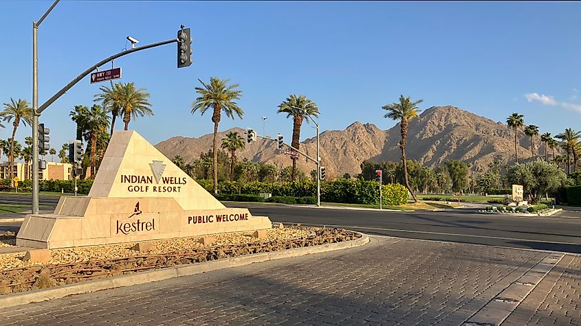 Sign for Indian Wells Golf Resort with scenic mountains in the background