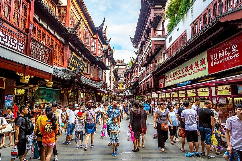 Locals and tourists at a busy marketplace in Shanghai, China. Editorial credit: LMspencer / Shutterstock.com