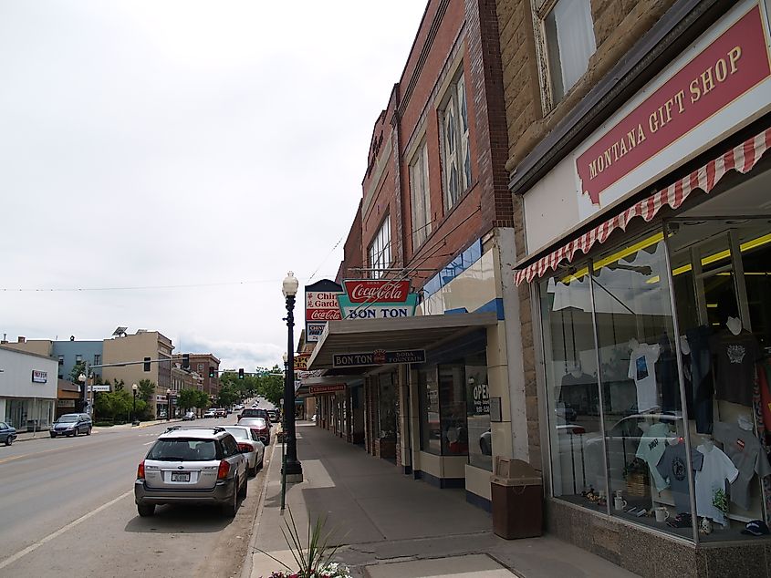 Street view of Lewistown, Montana, showing buildings, shops, and vehicles along a typical small-town street.