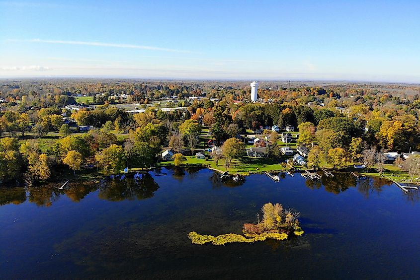 The aerial view of the waterfront residential area by Oneida Lake with stunning fall foliage near Syracuse, New York.