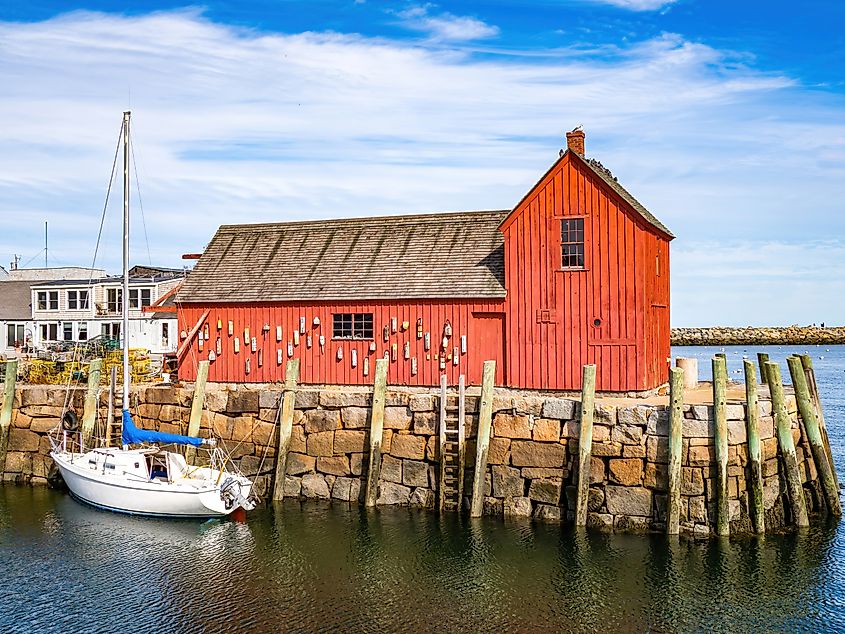 Fishing shack in Rockport with pretty sky and a boat.