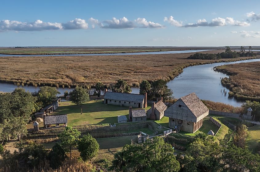 Aerial view of Fort King George historic site, oldest English fort on the Georgia coast from the 17th century with wooden palisade, gun ports for cannons blue cloudy sky near Darien, Georgia, USA.