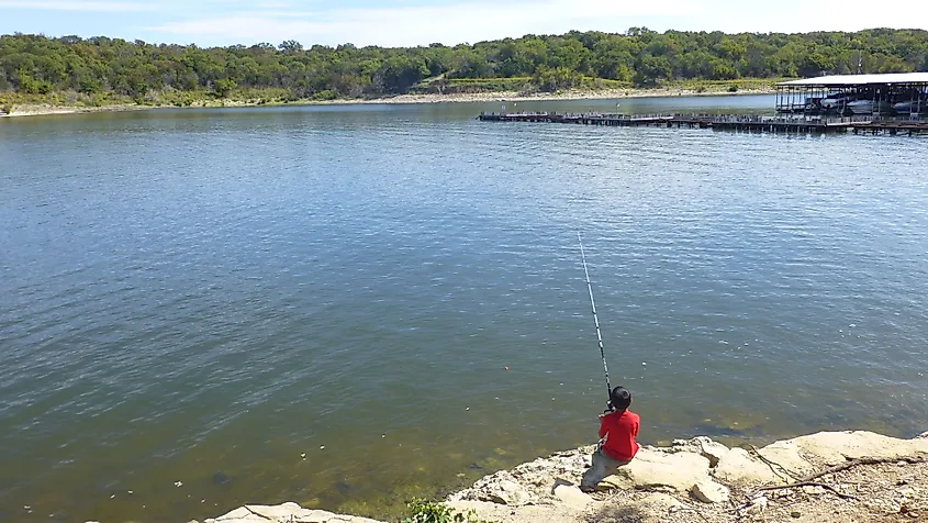 A boy fishing in Lake Texoma at Eisenhower State Park, Texas