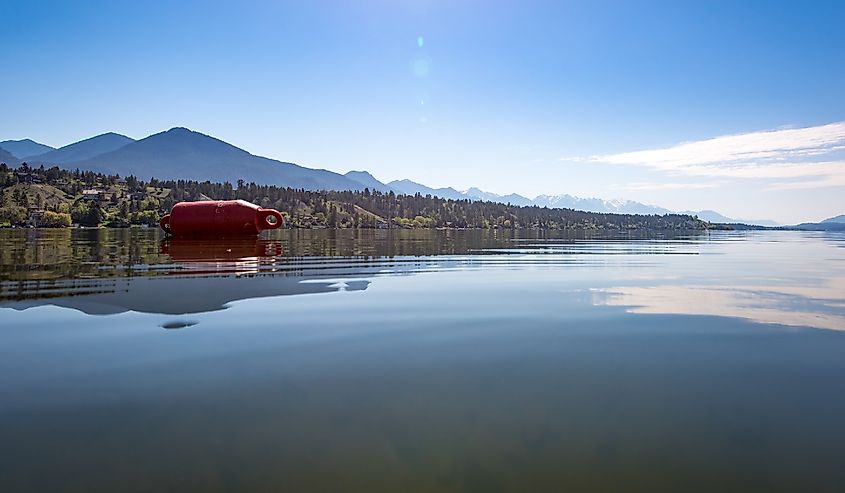 Perfect reflection on the beach of Lake Windermere at James Chabot Provincial Park in Invermere, British Columbia, Canada on a beautiful sunny summer morning