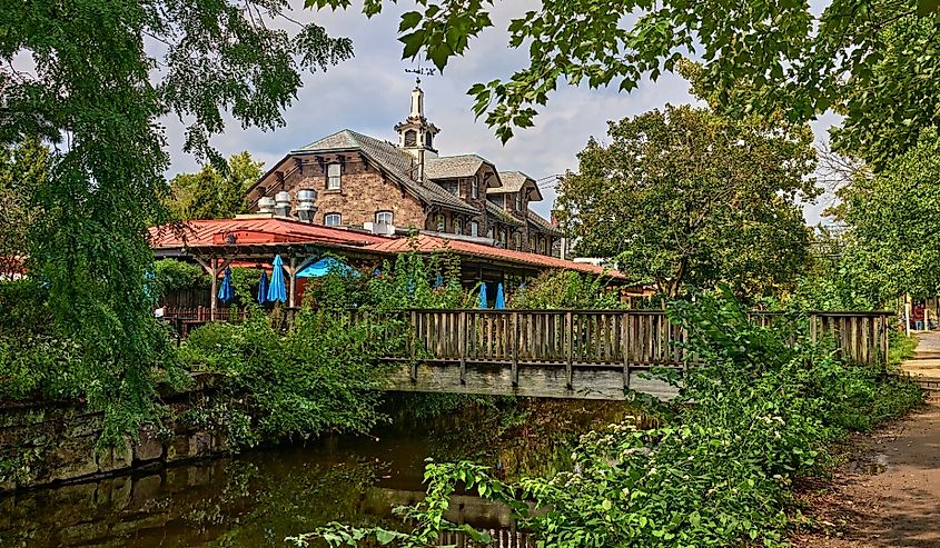 Small wooden bridge crossing the Delaware River Canal with reflections. Taken looking towards Bridge Street in Lambertville, New Jersey.