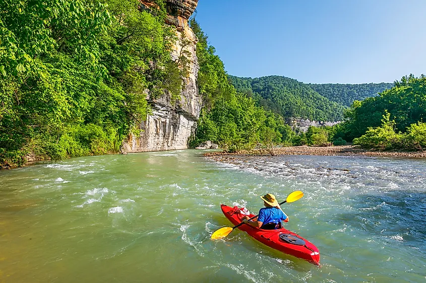 A kayaker floating down the Buffalo River near Ponca, Arkansas.