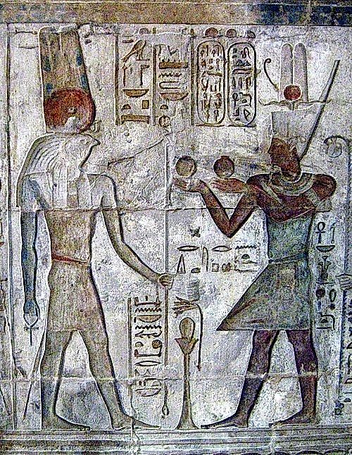 Relief depicting Ptolemy IV making an offering to Montu, the Falcon God of War of ancient Egypt at Deir el-Medina, Egypt.