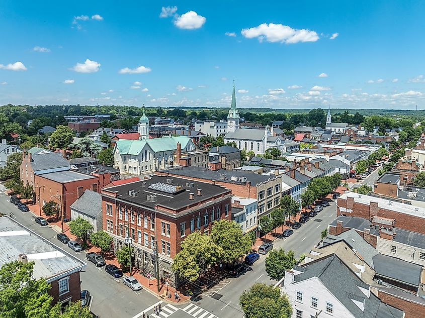 Aerial view of Fredericksburg, Virginia, showcasing the Circuit Court building, historic business district, Baptist church, and Chatham Bridge spanning the Rappahannock River.