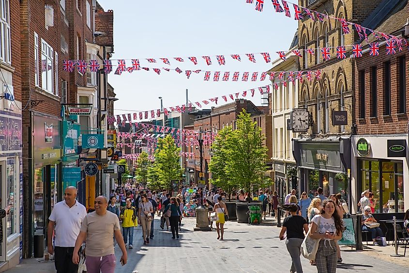 Old Windsor high street with people and cars on the road, Windsor, England.