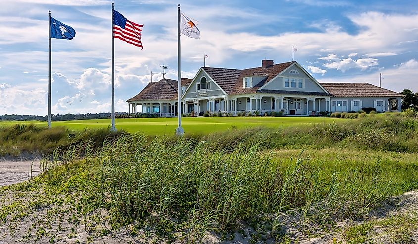 Kiawah Islands famous Ocean Course is iconic to golfers with the sand in the foreground, three flag poles along with the resort in background.