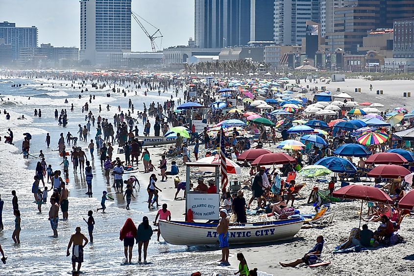 The beaches of Atlantic City absolutely packed with people, umbrellas, and boats.