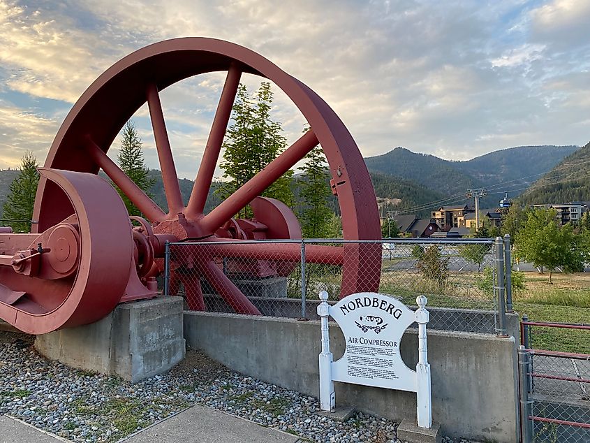 A large red wheel that served as part of an air compressor for a historical smelter.