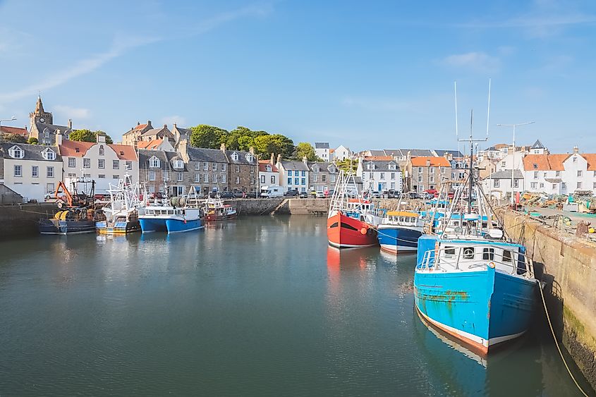 Colourful fishing boats moored at the harbour in the scenic East Neuk seaside village of Pittenweem, Fife, Scotland, UK.