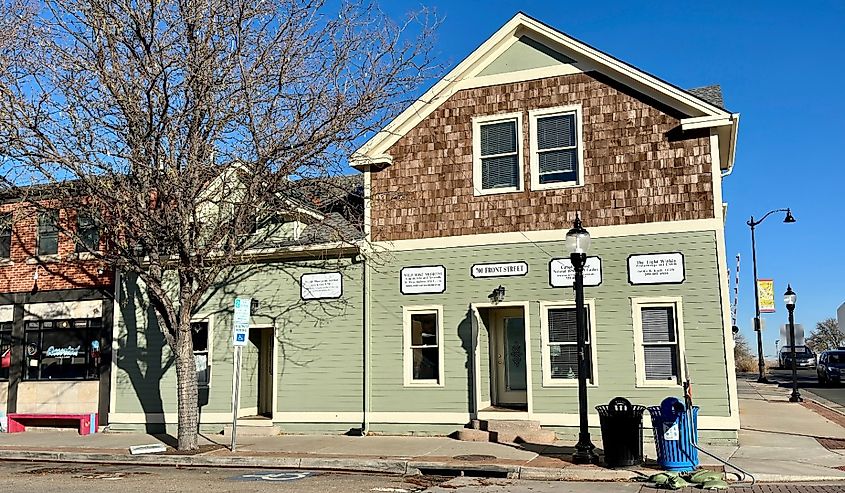 Front Street business building, painted green, with autumn light, Louisville, Colorado.