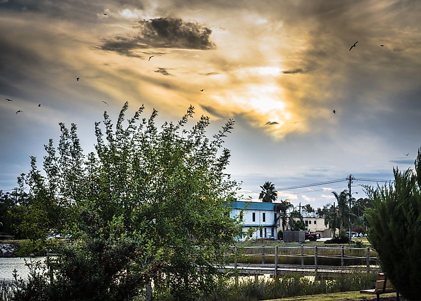 The sun sets over Jarboe Bayou and the island of Clear Lake Shores, Texas