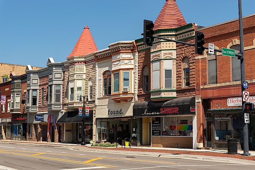 Exterior view of downtown buildings and storefronts in DeKalb, Illinois, showcasing a mix of historic and modern architecture.