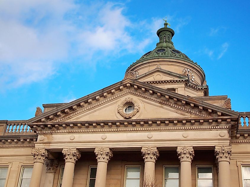 Detailed view of the Somerset County Courthouse in Pennsylvania, highlighting its classical pediment, dome, and column architecture in Uptown Somerset