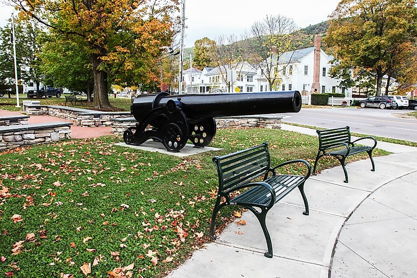 Street view in downtown Bristol, Vermont, featuring a historical cannon.