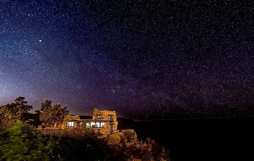 Stars in the night sky with the Lookout Studio in the foreground at the Grand Canyon South Rim, Arizona, USA. Editorial credit: Nigel Jarvis / Shutterstock.com