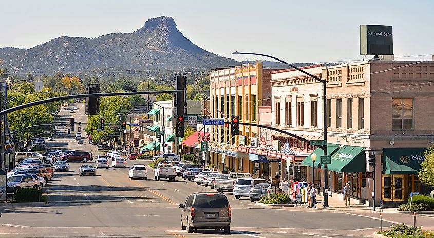 Street view of Prescott, Arizona, featuring historic buildings, local shops, and tree-lined sidewalks in a charming downtown setting.