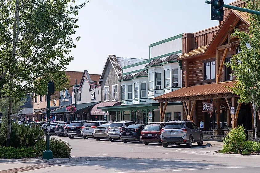 Shops and businesses in downtown Whitefish, Montana, lining the streets on a summer day.