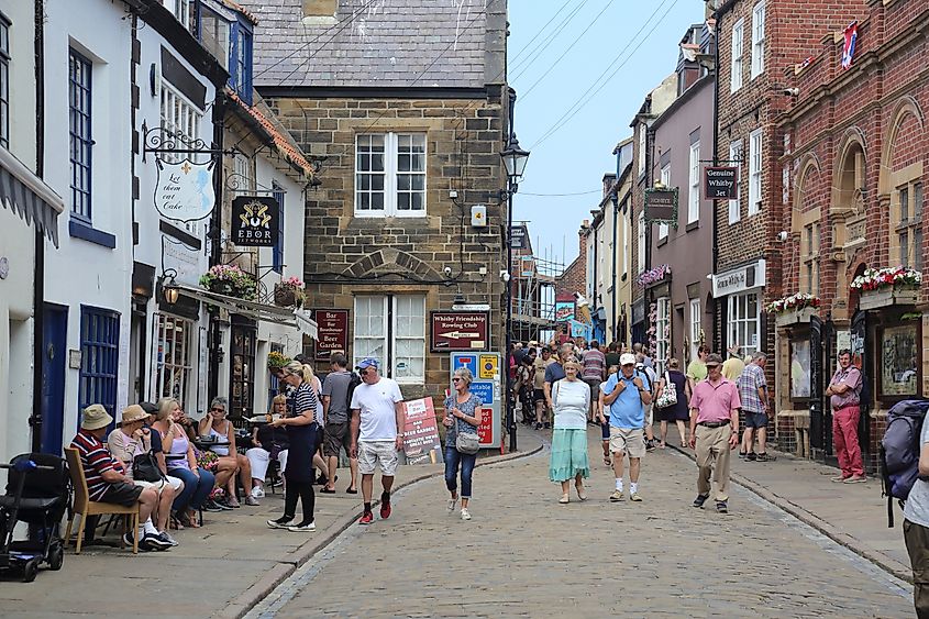 People walking along a street in Whitby, England.