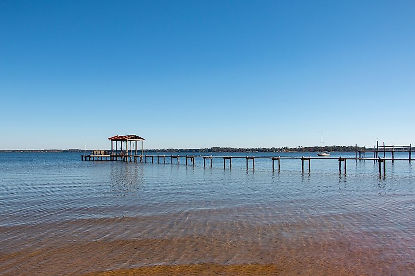 Boat pier dock in Lillian, Alabama, with blue sky tranquil setting.