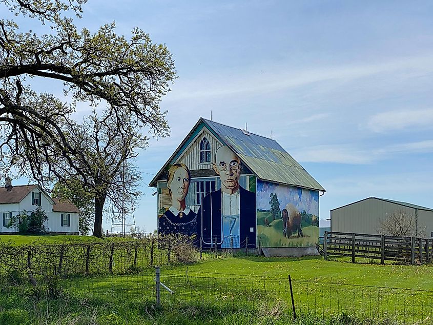 Mount Vernon, Iowa: American Gothic Barn, a barn-sized rendition of Grant Wood's famous painting, featuring a farming couple and nearby Iowa gothic farmhouse.