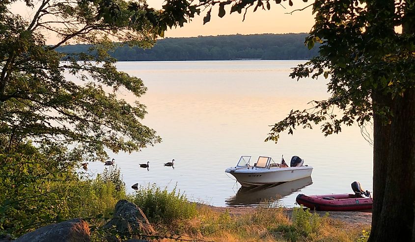 Two small boats at sunset at Watchaug Pond in Burlingame State Park, Charlestown, Rhode Island.