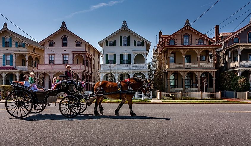 A carriage carries tourists past a row of Victorian "gingerbread" houses in Cape May, New Jersey.