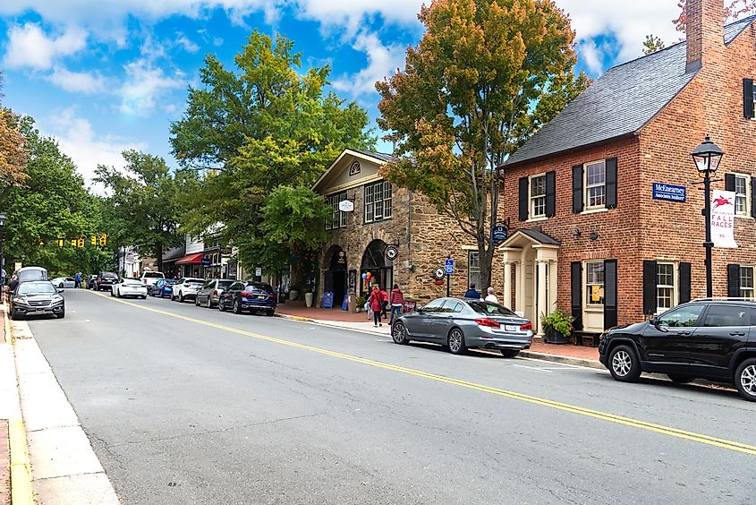 Central street of Middleburg, Virginia, featuring ancient buildings housing shops, hotels, and restaurants. Tourists stroll along the historic streets of this town near Washington, D.C.