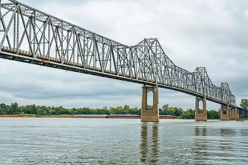 The cantilever Cairo Ohio River Bridge stretching across the river, surrounded by beautiful fall scenery. The steel structure provides a vital crossing between Wickliffe, Kentucky, and Cairo, Illinois. 